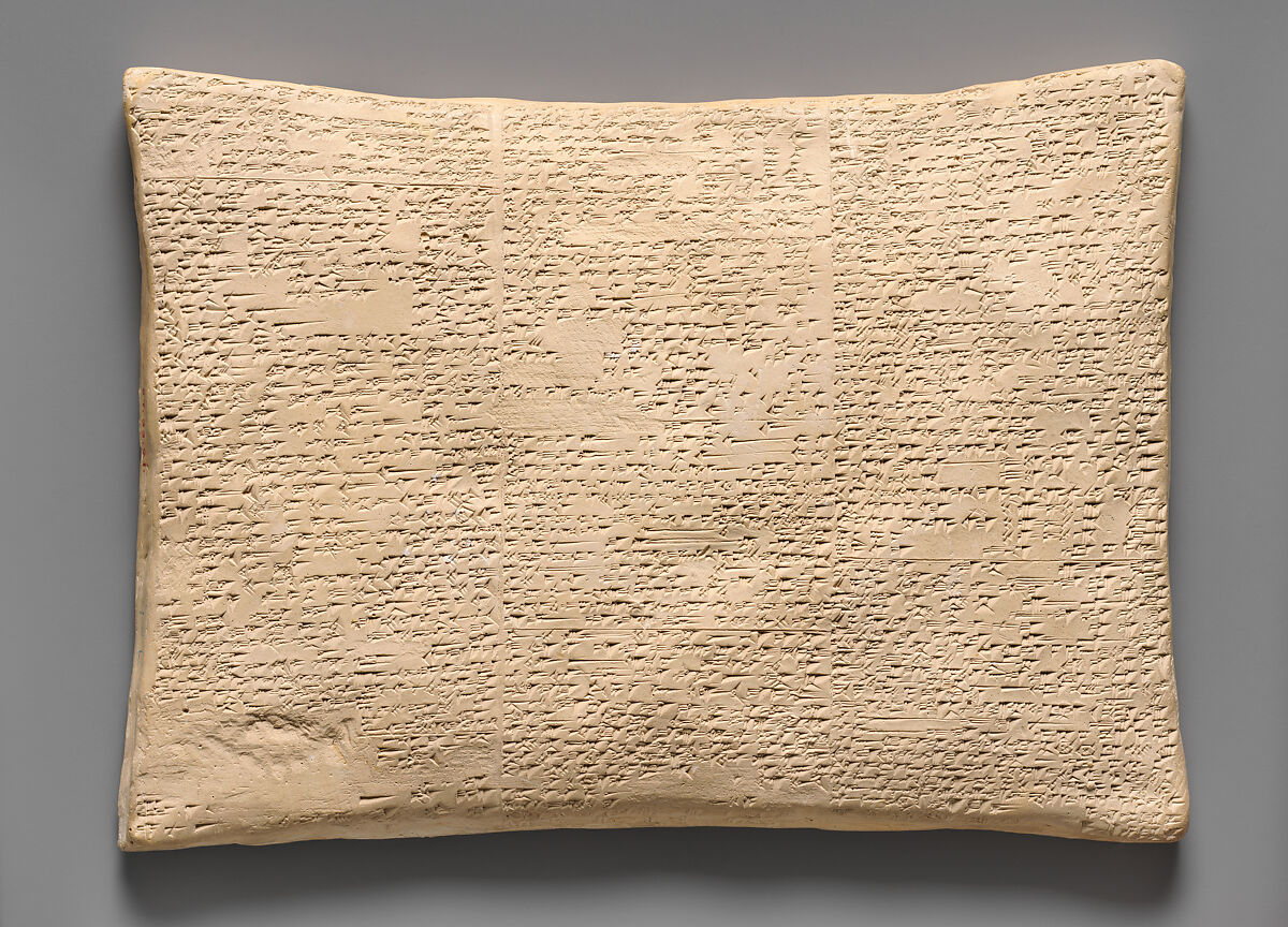 Plaster cast of a cuneiform tablet with dense lines of wedge-shaped writing
